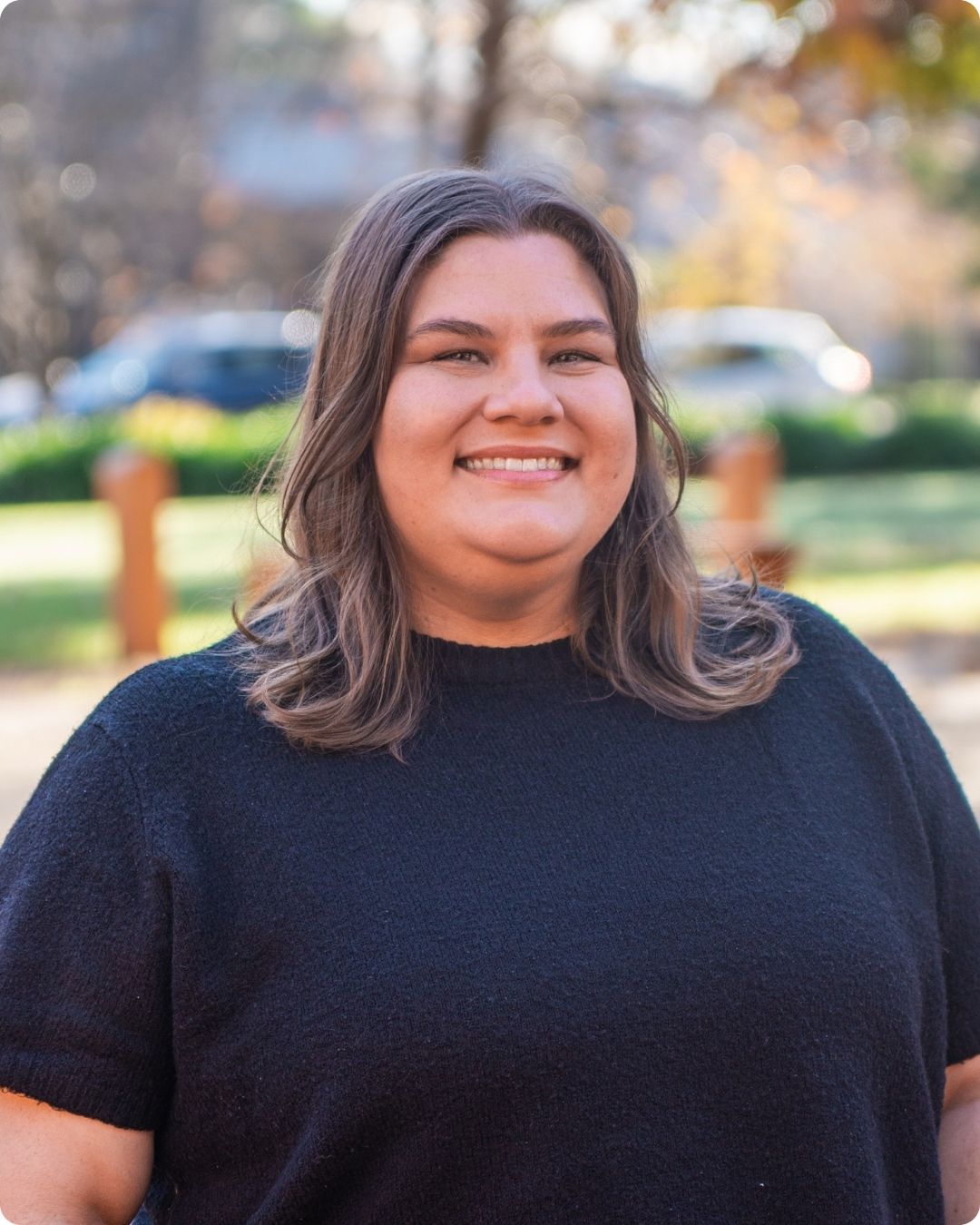a picture of sarah, smiling, wearing a black shirt